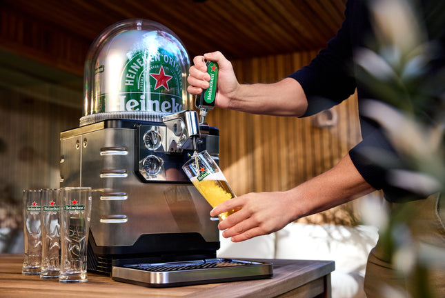 A person pouring a glass of beer from BLADE beer machine
