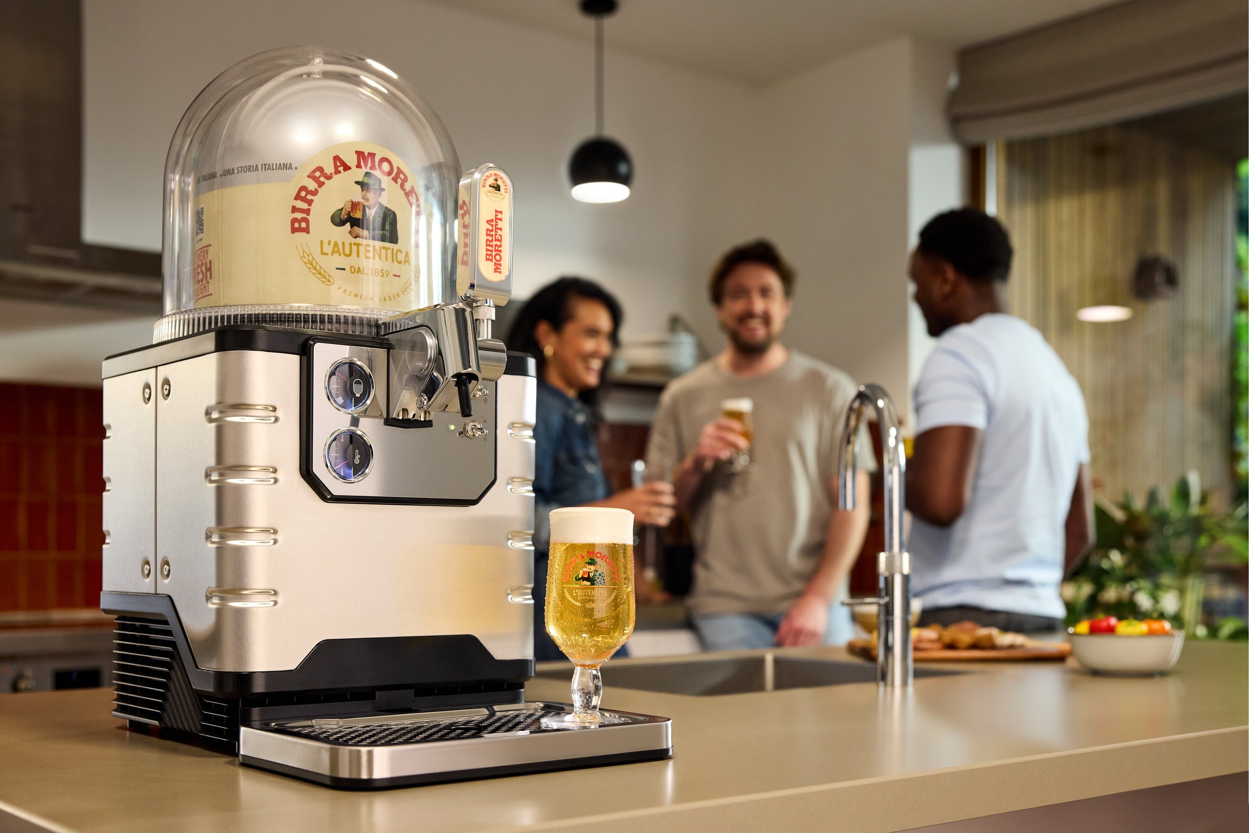 BLADE beer machine with people enjoying beer in the background