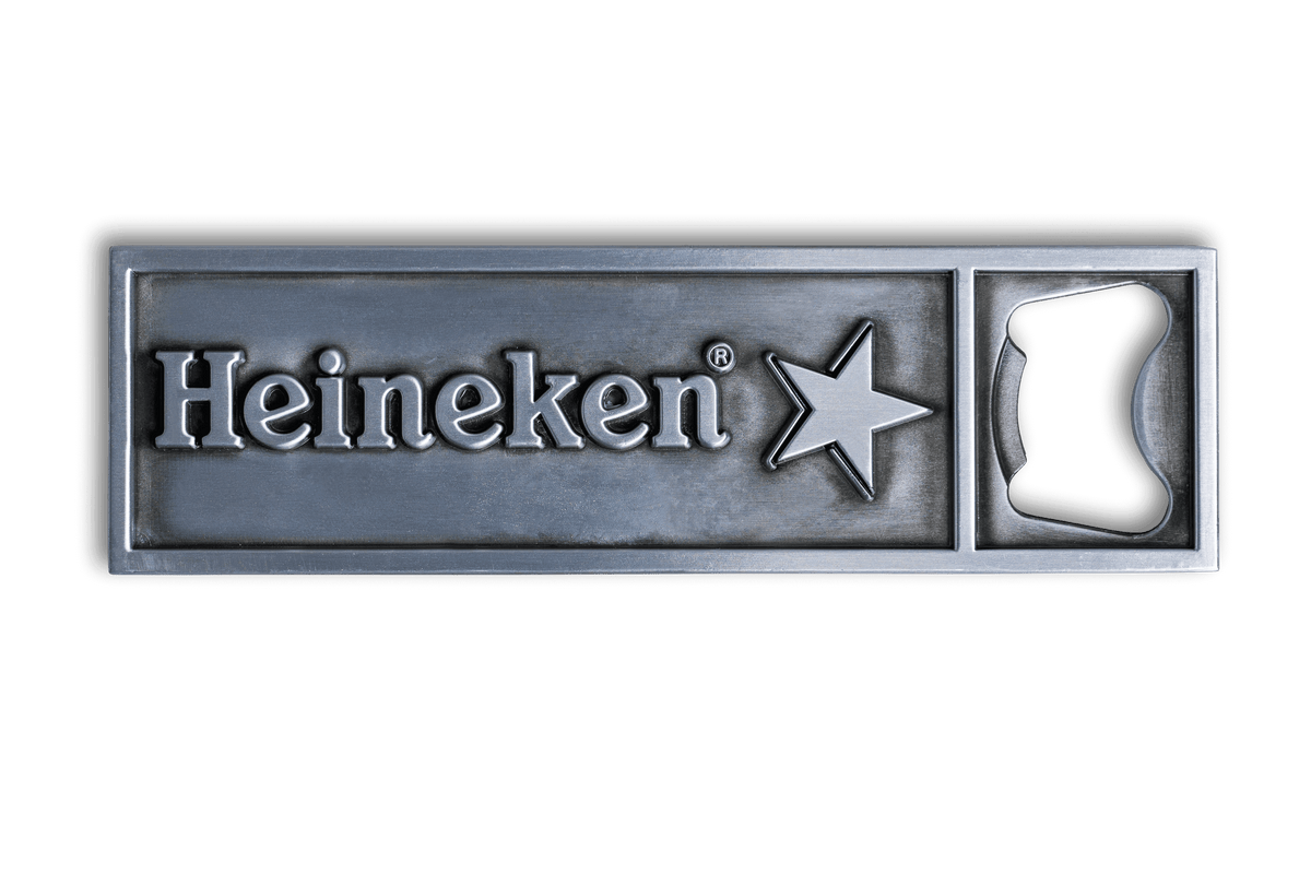 A silver metal bottle opener with the Heineken logo embossed on it, featuring an opener slot on one end.