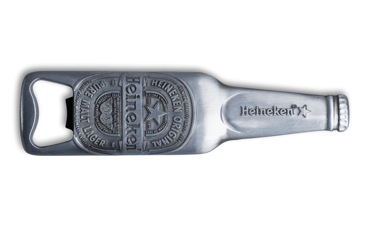A silver-colored magnetic bottle opener designed to resemble a Heineken beer bottle, with the Heineken logo embossed on it.