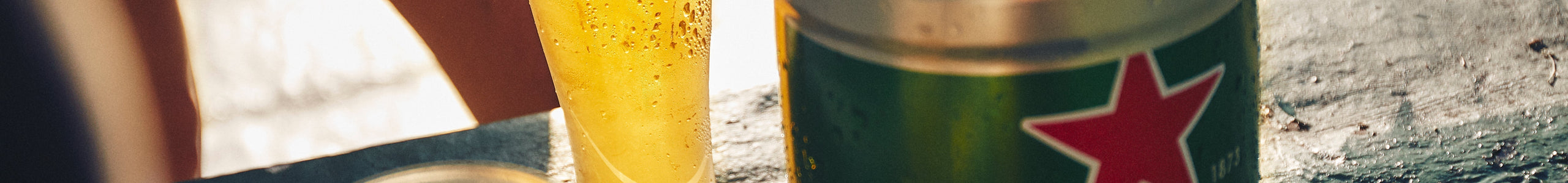 Heineken glass and Heineken 5L keg in the sun