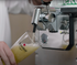 A hand pouring a glass of Heineken beer from a BLADE beer machine.