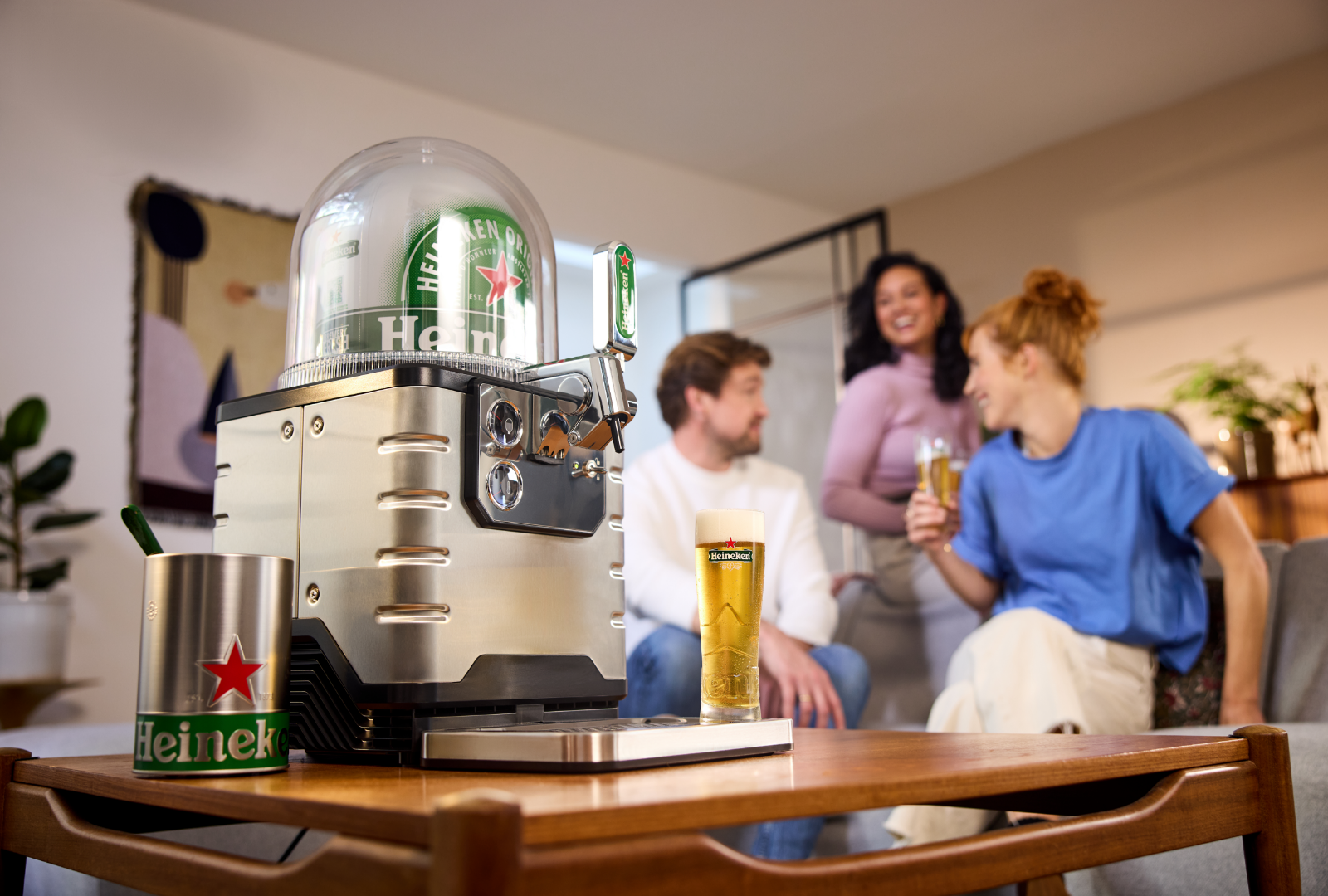 A BLADE beer machine with people enjoying beer in the background