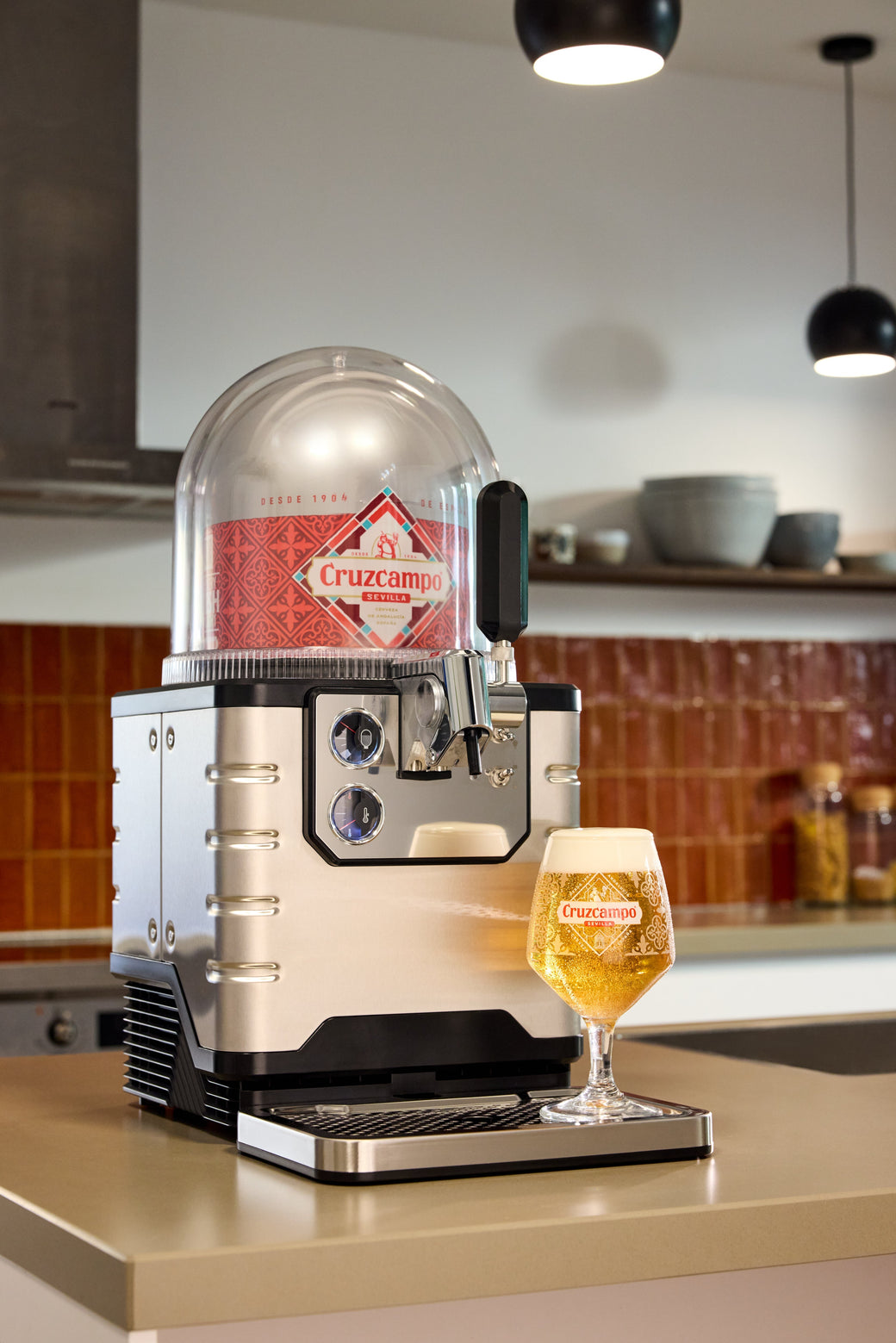 BLADE beer machine on a kitchen counter with a glass of beer.