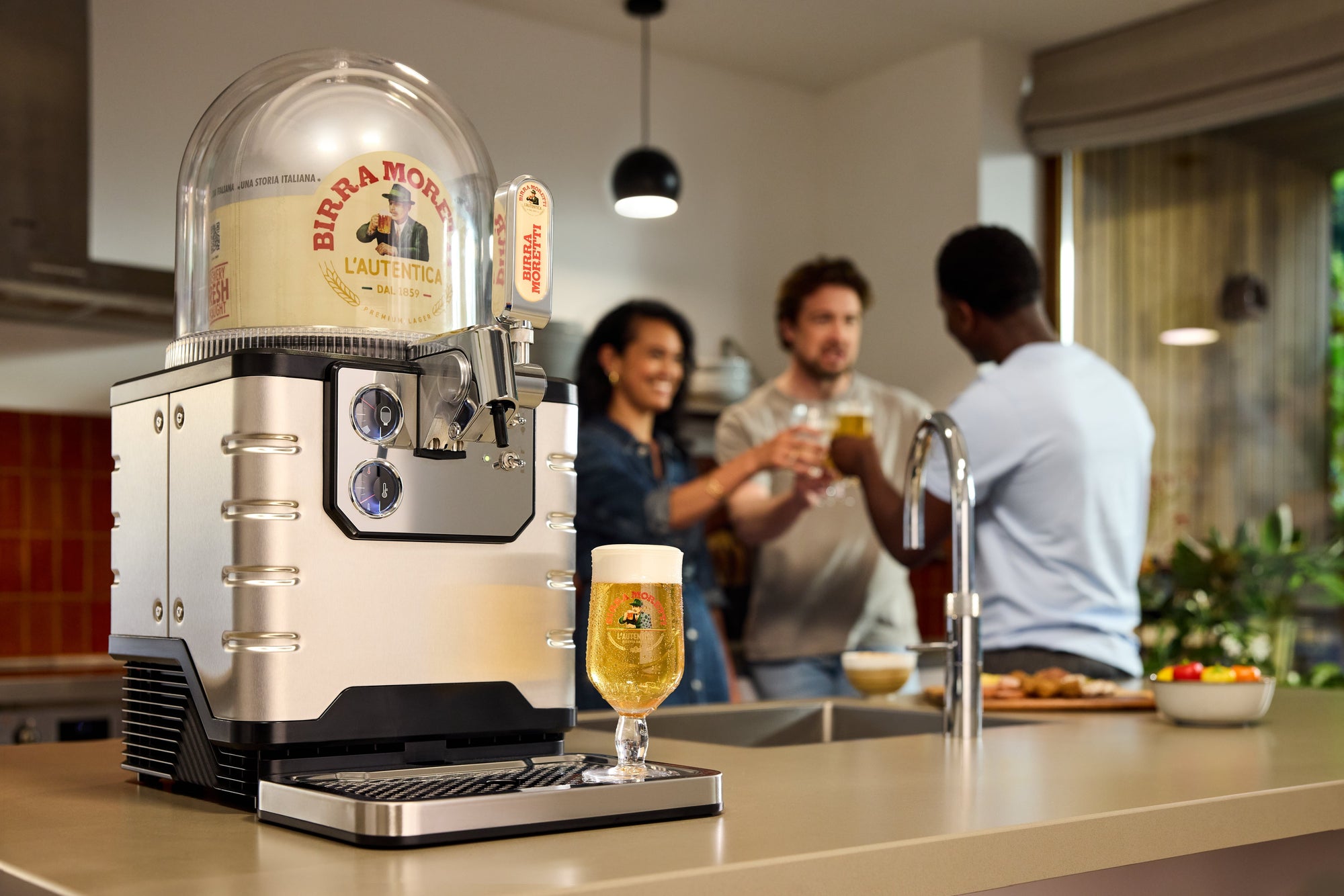 BLADE beer machine on a kitchen counter with people in the background