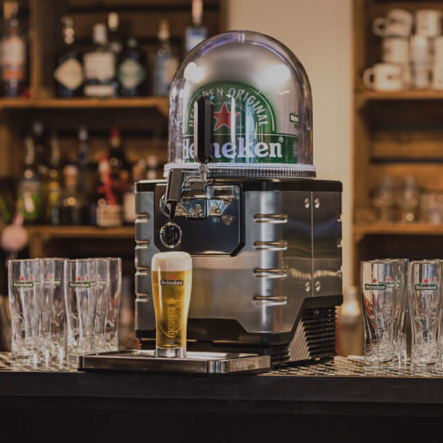 A BLADE beer machine loaded with a Heineken beer keg and a freshly poured glass of Heineken on the drip tray.