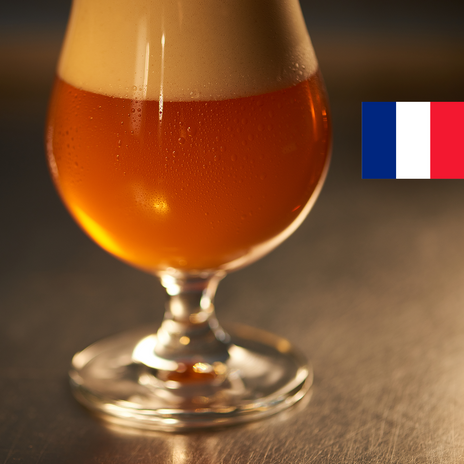 A full glass of pale golden beer with the flag of France in the top right corner.