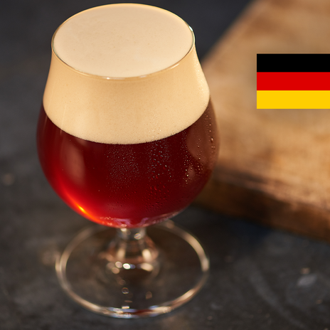 A full glass of amber beer with the flag of Germany in the top right corner.