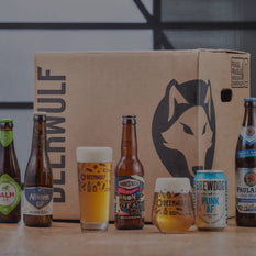 Beer bottles, one beer can and two Beerwulf beer glasses in front of a Beerwulf box