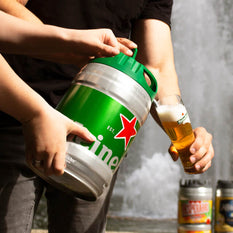 Two people filling up a beer glass from a 5L draught keg of Heineken beer.