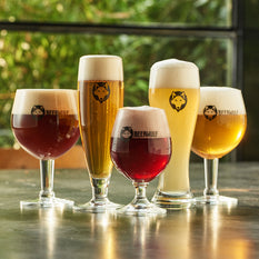 Five different Beerwulf beer glasses filled with various styles of beer.